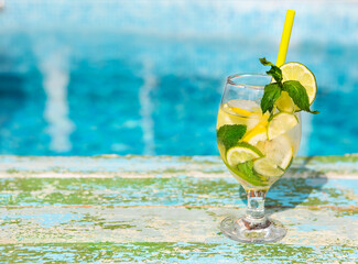 Glasses of homemade lemonade on a rustic wooden background