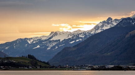 sunrise over the mountains of switzerland at upper lake zurich - obrazy, fototapety, plakaty