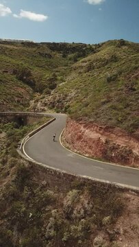 Outdoor sport in the Canary Islands, Cyclists between mountains, Difficult roads of Gran Canaria. Vertical Drone Recorded Cycling to 4K Quality.