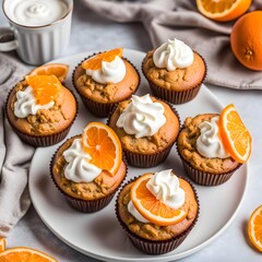 the muffins are heavily garnished with whipped cream and orange slices
