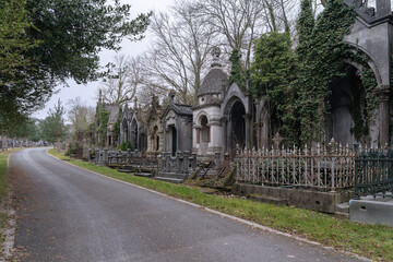 Old European cemetery. Ancient crypts on both sides of the road.