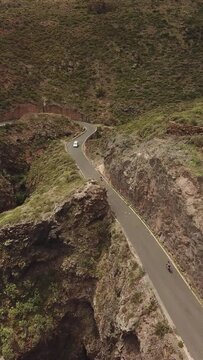 Epic Routes in the Canary Islands, Cyclists in the Mountains, difficult roads in Gran Canaria, vertical drone recorded cycling in 4k quality
