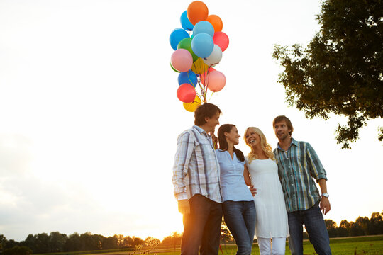 friends, two couples in summer with lots of balloons