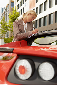 young woman with an electric car