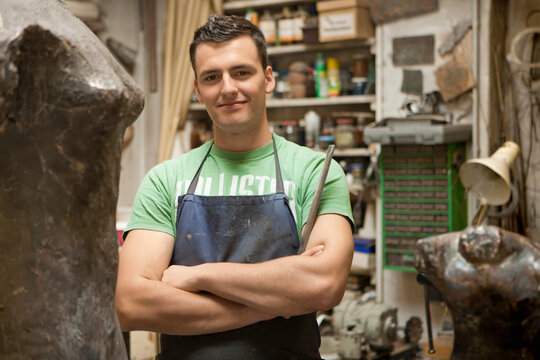 Young artist working on a sculpture in an atelier. Munich, Bavaria, Germany
