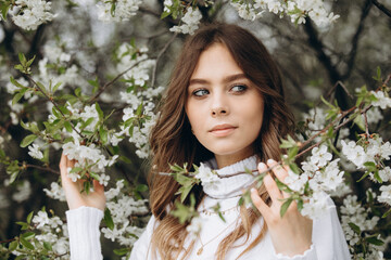 
portrait of a young girl with long hair on the street. spring portrait. Awakening female beauty