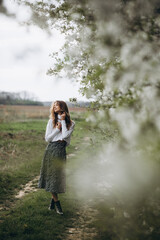 
portrait of a young girl with long hair  on the street. spring portrait. Awakening female beauty
