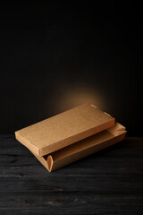 craft paper boxes for food packaging on a black background. Fast food delivery. Mockup