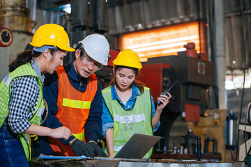 Asian engineer or technician man foreman training female trainee using program or system in...