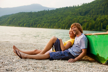 Couple playing and enjoying a summer day at a lake. Walchensee, Germany