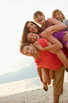 Group of friends playing and enjoying a summer day at a lake. Walchensee, Germany
