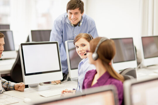 Colleagues working in a call center with a very friendly atmosphere. Munich, Germany