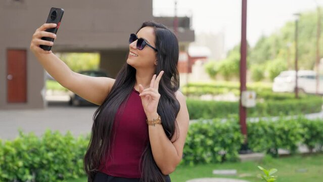 Indian Woman with Sunglasses clicking Selfie