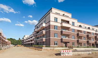 Fotobehang construction site of multi-storey residential buildings © Lichtwolke99