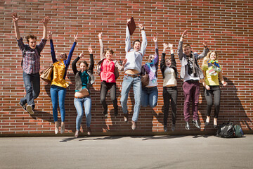 Group of students on campus jumping for joy. Munich Germany