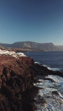 Coastal village on the cliffs, north of Gran Canaria, Canary Islands to drone in 4k, vertical plane