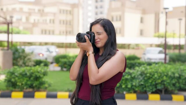Indian Woman Clicking Pictures with Camera
