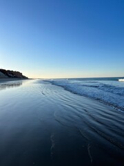 Evening sea coast, sandy sea coastline, clear sky, sea horizon