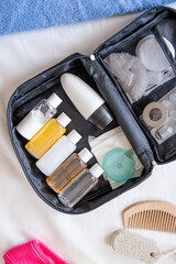 Travel cosmetics kit on bed , top view