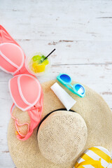 Beach accessories on white wooden background
