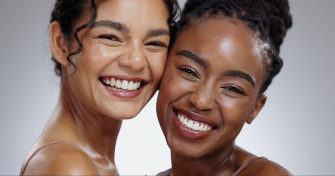 Women, face and skincare with laughing in studio with facial treatment, diversity or glowing skin. Friends, model and portrait with beauty for cosmetics, dermatology and support on gray background