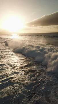 Waves at sunset in the North Sea of Gran Canaria, recorded vertically with drone in 4K