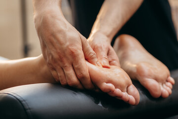 Close up male hands doing foot massage	
