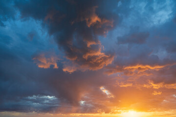 Glowing real sky at sunset texture background overlay. Dramatic red and orange clouds.