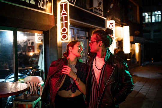 Young couple walking in the city during night