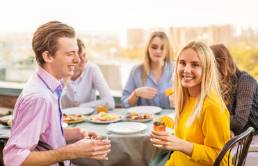 Cheerful friends drinking alcohol during banquet