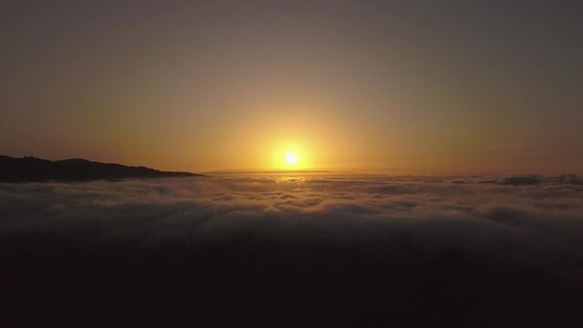 Flying with drone over the sea of clouds in the Canary Islands, clouds and ravines in Gran Canaria, sunset over clouds recorded with drone in 4k