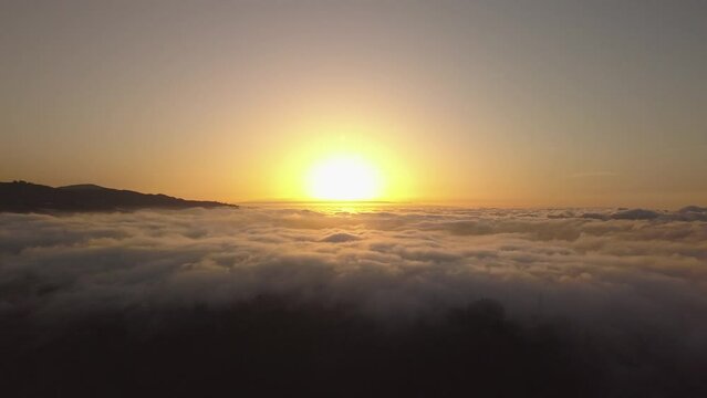 Flying with drone over the sea of clouds in the Canary Islands, clouds and ravines in Gran Canaria, sunset over clouds recorded with drone in 4k