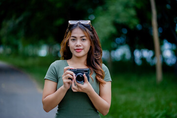 Beautiful Asian tourist and her personal camera female photographer Surround Milleles