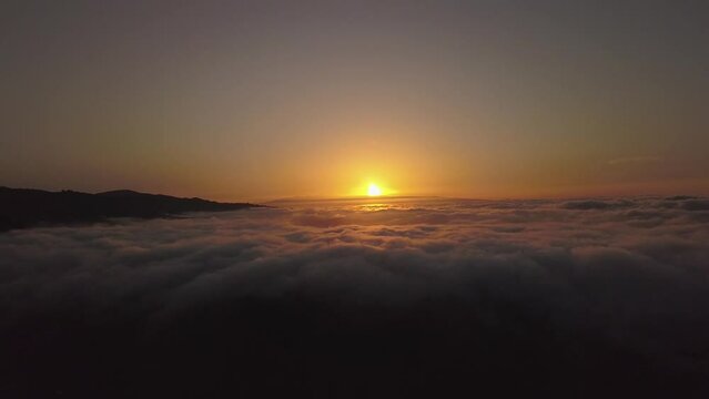 Flying with drone over the sea of clouds in the Canary Islands, clouds and ravines in Gran Canaria, sunset over clouds recorded with drone in 4k
