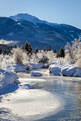 Frozen river of golden dreams with a view of Whistler Mountain, Canada