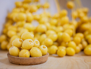 Close up and selective focus fresh dates fruits in wooden bowl.