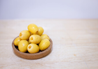 Close up and selective focus fresh dates fruits in wooden plate in copy space concept.