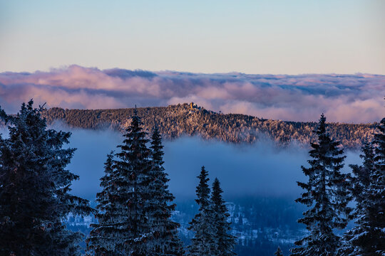 Cloudy sunset in the polish Karkonosze Mountains - winter panorama with a view of the Wysoki Kamień shelter 