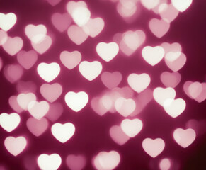 Pink blurred abstract background with cute bokeh hearts for mothers day.