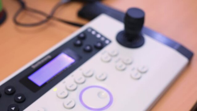Close-up remote control panel with joystick and ring.