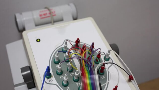 Electroencephalography box with sockets and connected wires.