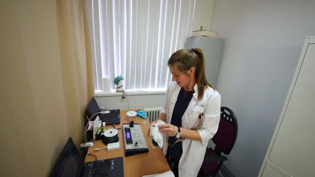 doctor in lab coat clean cap from electrically-conductive gel.