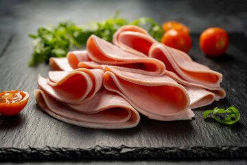 fresh ham slices, over dark background