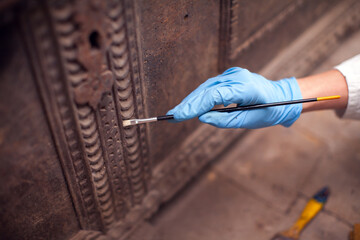 Female Adult Restorer Impregnates Parts of Wooden Old Traditional Slovenian Casket with Anti-Rot...