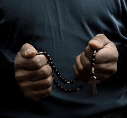 man praying to god Caribbean man praying with black grey background with people stock photo	