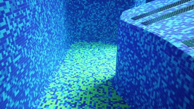 Under water view on new transparent pool with blue tiles