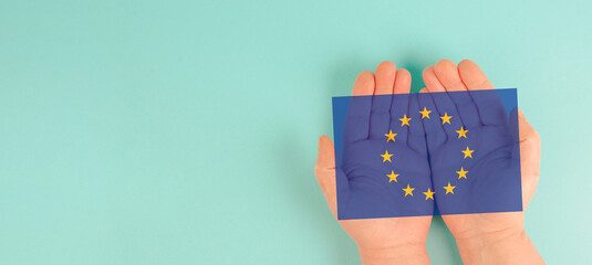 Hand with EU flag, european union, cooperation between the countries of Europe, Association of...