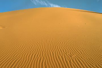 SAHARA DESERT WITH SAND DUNES AND PATTERNS IN TADRART ROUGE REGION NEAR DJANET OASIS IN ALGERIA