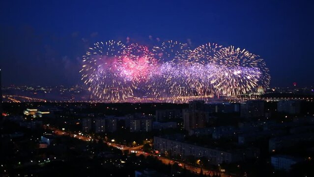 Residential district of city with bright fireworks at evening
