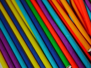 Multicolored paper drinking straws close up 